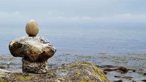 Stack stones on the coast of sea at cloudy weather. Life balance and harmony Stock Footage 155231893