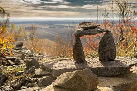 Stack of stones of different sizes and shape under the sunlight in fall Stock Photos