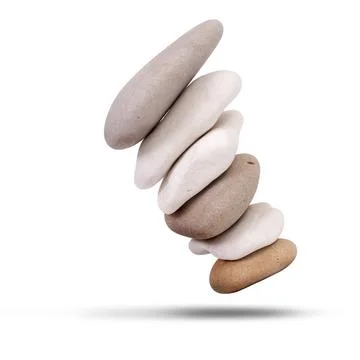 Stack of stones falling over isolated on white 写真素材