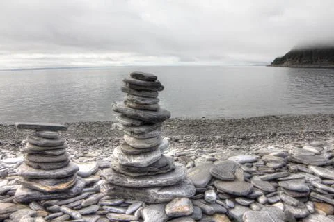 Stack of stones on fjord background 스톡 사진