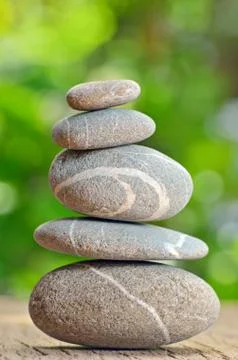 Stack of stones on a wooden table Stock Photos