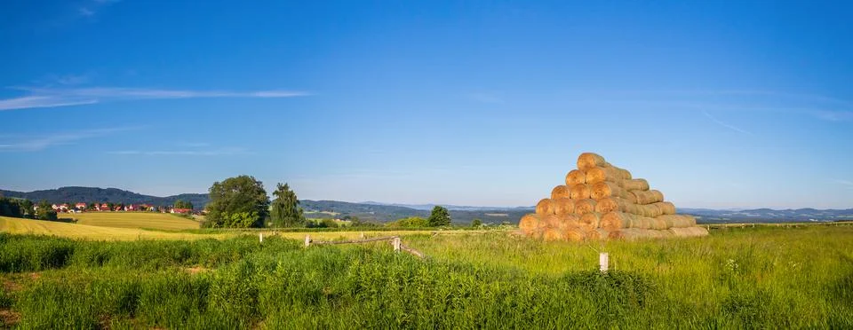 Stack of straw bales on field of grass Stock Photos