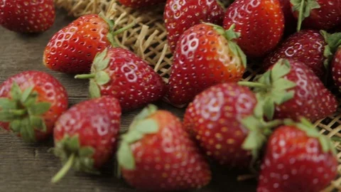Stack of strawberries on wood table, pan shot Stock Footage 105440969