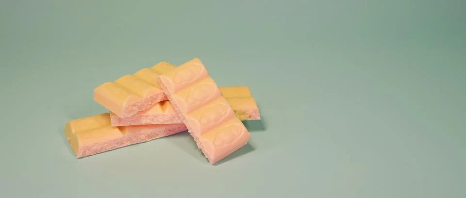 A stack of strawberry flavored milk chocolate bars with bubbly texture Stock Photos