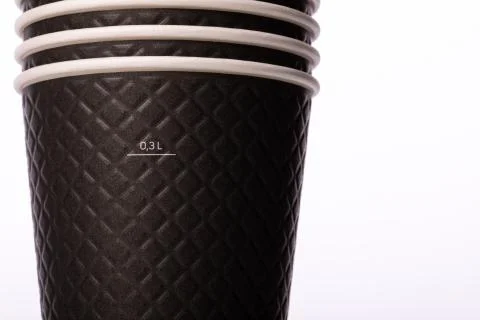 Stack of stylish black paper cups on isolated white background. Mug of 300 ml Stock Photos
