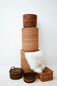 Stack of stylish handmade wicker straw osier baskets for home storage Stock Photos