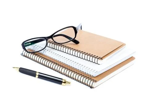 Stack stylish notebook, pen and glasses. Stock Photos