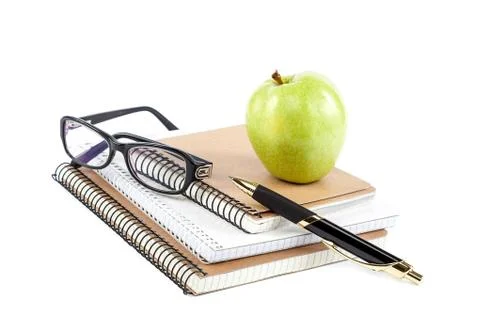 Stack stylish notebook, pen and glasses Office or school supplies. Stock Photos