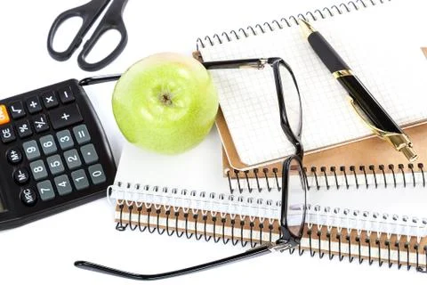 Stack stylish notebook, pen and glasses. Office or school supplies. Stock Photos