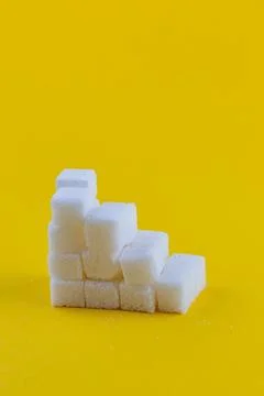 Stack of sugar cubes arranged in an abstract pattern on a bright background 스톡 사진