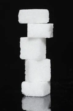 Stack of sugar cubes on black background 写真素材