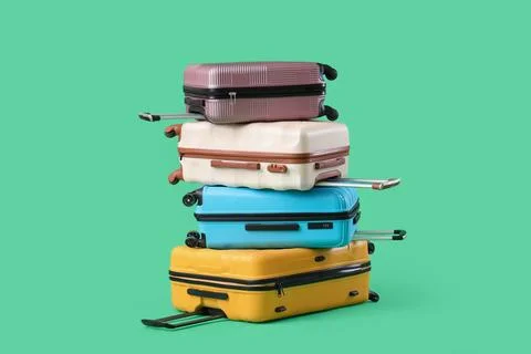 Stack of suitcases on green background Fotos de archivo