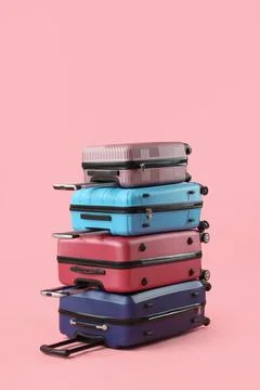 Stack of suitcases on pink background Fotos de archivo