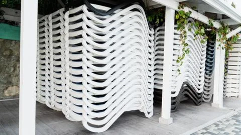 Stack of a sun loungers on the beach. End of summer season. Abstract backgrou Foto stock