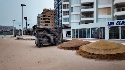 Stack of sun loungers on deserted beach, Calpe, Costa Blanca, Spain Stock Footage 342317842