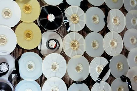 Stack of supply and take up reels with ribbon of VHS video cassette tapes use Stock Photos