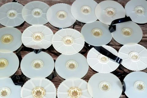 Stack of supply and take up reels with ribbon of VHS video cassette tapes use Stock Photos
