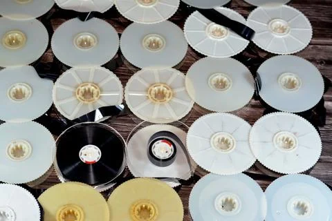 Stack of supply and take up reels with ribbon of VHS video cassette tapes use Stock Photos
