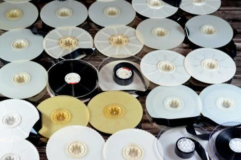 Stack of supply and take up reels with ribbon of VHS video cassette tapes use Stock Photos