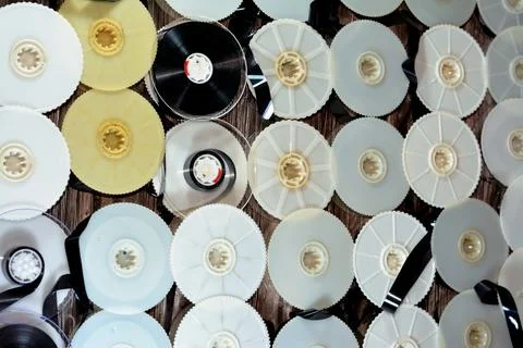 Stack of supply and take up reels with ribbon of VHS video cassette tapes use Stock Photos