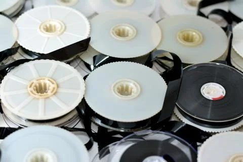 Stack of supply and take up reels with ribbon of VHS video cassette tapes use Stock Photos