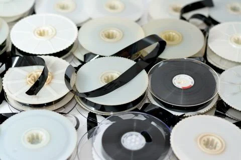 Stack of supply and take up reels with ribbon of VHS video cassette tapes use Stock Photos