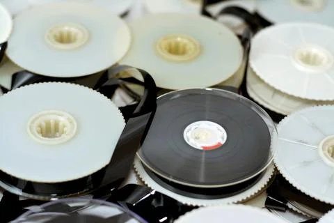Stack of supply and take up reels with ribbon of VHS video cassette tapes use Stock Photos
