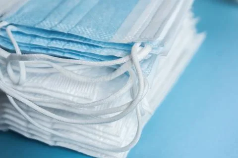 Stack of surgical face masks,background white and blue Stock Photos