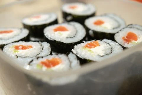A stack of sushi in a container. sushi with fish close-up. Stock Photos