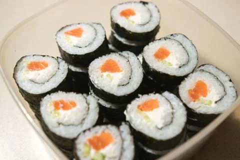 A stack of sushi in a container. sushi with fish close-up. Stock Photos