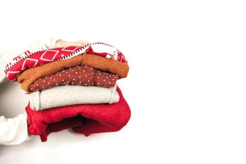 Stack of sweaters in hands Stock Photos