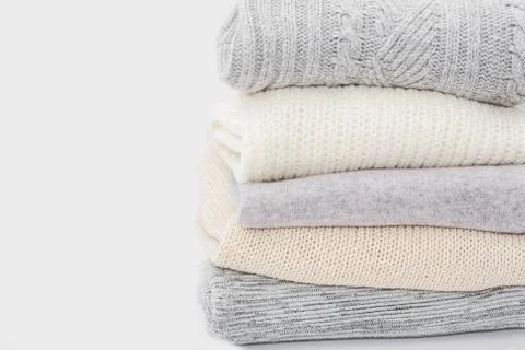 Stack of sweaters isolated on white Stock Photos