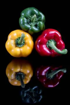 A stack of sweet bell peppers with reflections Foto stock