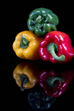 A stack of sweet bell peppers with reflections Stock-Fotos