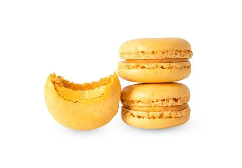 Stack of sweet orange and one bitten macaroons isolated on white background Stock Photos