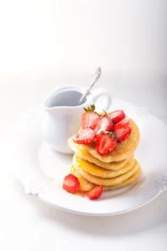 Stack of sweet pancakes with strawberry and honey. Stock Photos