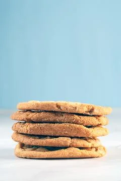 Stack of sweet white chocolate chip cookies isolated on a soft blue background 스톡 사진