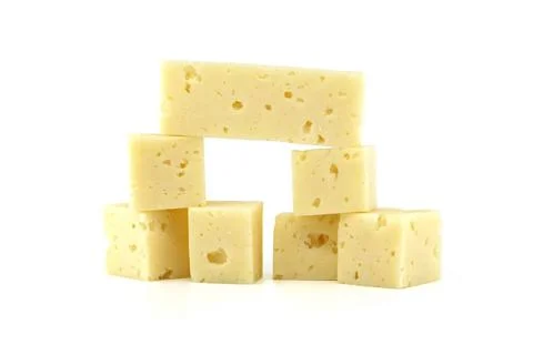 Stack of Swiss cheese cubes isolated on white background A stack of Swiss ... 스톡 사진