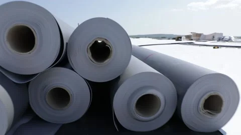 Stack of synthetic pvc membrane rollers on a flat roof Stock Footage 143149370
