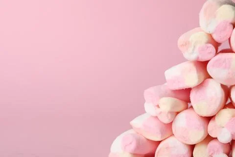 Stack of tasty marshmallows on pink background, closeup. Space for text 写真素材