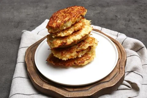 Stack of tasty parsnip cutlets on grey textured table 스톡 사진