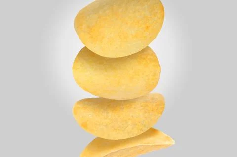 Stack of tasty potato chips on light grey background Stock Photos