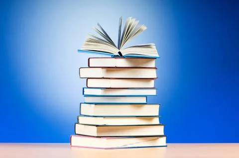 Stack of text books against gradient background Stock Photos
