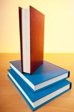 Stack of text books against gradient background Stock Photos