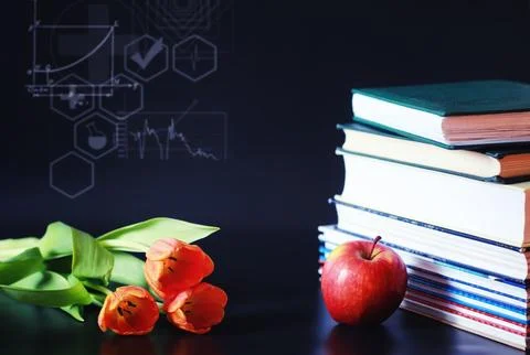 A stack of textbooks and books on the table. The concept of knowledge. Stock Photos