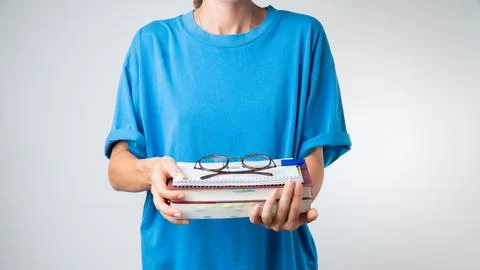 On a stack of textbooks and notebooks are glasses with transparent glasses in Stock Photos