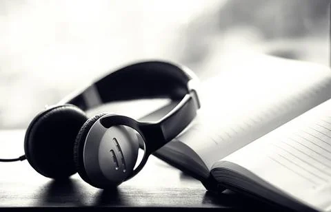 A stack of textbooks with headphone Stock Photos