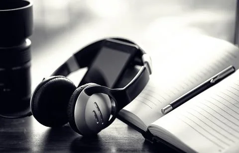 A stack of textbooks with headphone Stock Photos