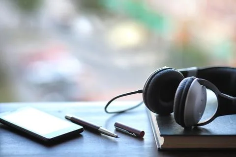 A stack of textbooks headphone Stock Photos