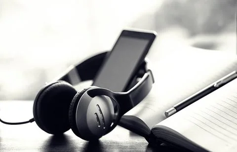 A stack of textbooks with headphone Stock Photos